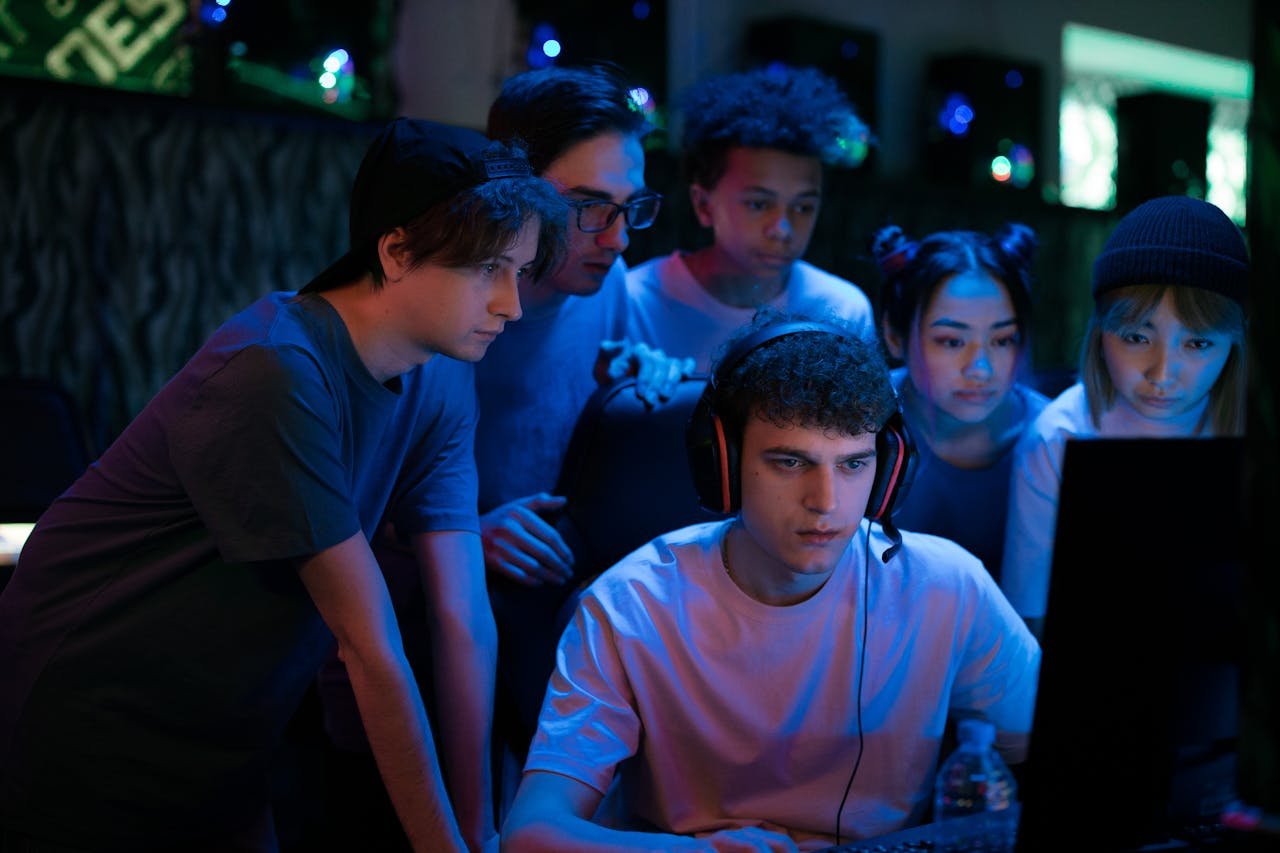 Group of diverse teenagers gaming together indoors, intense and focused.
